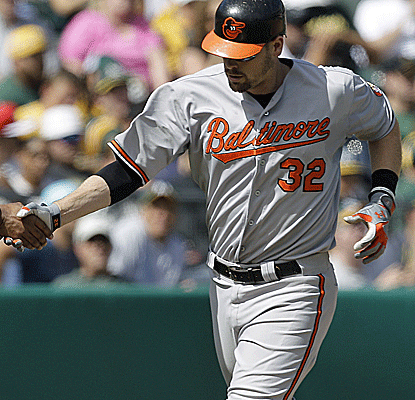 Matt Wieters connects for a pair of solo home runs as the Orioles get a win in Oakland to keep climbing in the wild-card race.  (AP)