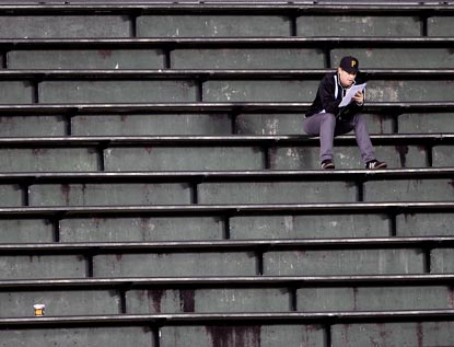 A truly dedicated Pirates fan soldiers on in the Wrigley Field bleachers during the eighth inning.  (AP)