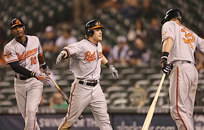 Nate McLouth (center) celebrates after scoring the go-ahead run in the 18th inning, which he began with a leadoff walk.  (Getty Images)
