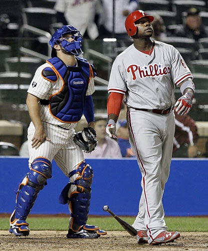 Ryan Howard and catcher Kelly Shoppach both watch Howard's 11th home run of the season sail over the wall in the ninth. (AP)