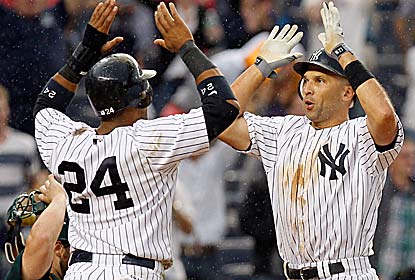 Raul Ibanez (right) hits his second of two homers -- a game-tying shot -- in the 13th for the Yanks, who win on an error. (Getty Images)