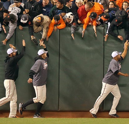 The Giants celebrate their second NL West pennant in three years with the home fans in San Francisco.  (Getty Images)