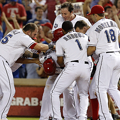 Adrian Beltre drives home the game-winner, extending the Rangers' divisional lead over the A's to five games.  (US Presswire)