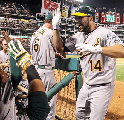 George Kottaras celebrates his tie-breaking home run in the 10th inning that lifts the A's over their division rivals.  (US Presswire)