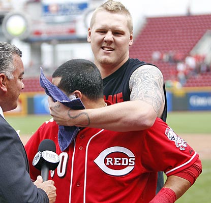 Dioner Navarro gets a shaving cream pie to the face from Reds starter Mat Latos after driving in the winning run.  (US Presswire)
