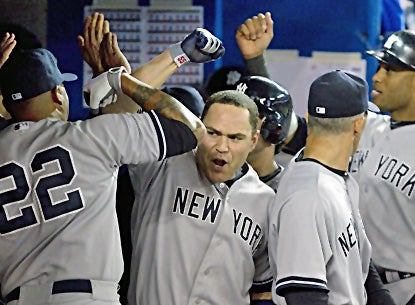 Russell Martin celebrates with Andruw Jones (left) after hitting a three-run home run during the sixth inning. (AP)