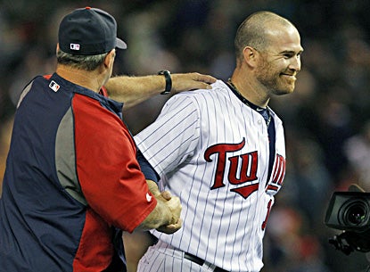Ryan Doumit is congratulated by batting coach Joe Vavra after the Twins' win. Doumit has a two-run home run and two-run double. (AP)