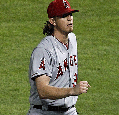 Jered Weaver becomes the first AL pitcher to reach 20 wins as the Angels keep their slim playoff hopes alive.  (AP)