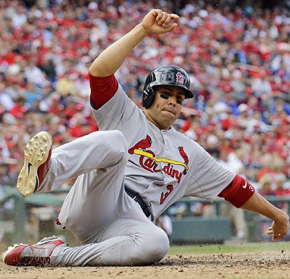 Carlos Beltran continues to excel in the postseason, going 2 for 4 in Game 3 and scoring the Cards' final run.  (AP)