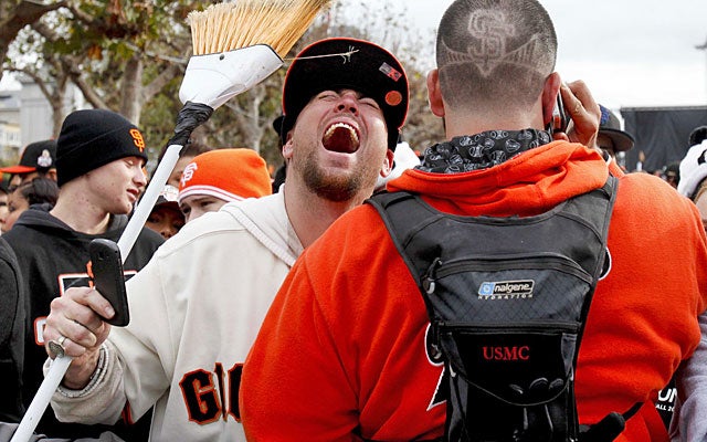 Fans carry reminders of the Giants' World Series sweep of the Tigers during the parade. (US Presswire)