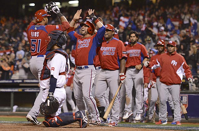 Team Puerto Rico pours out of their dugout to greet Alex Rios after he hits a two-run home run. (USATSI)