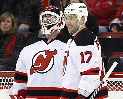 A bemused Martin Brodeur is congratulated by Ilya Kovalchuk (17) after getting credited with his third NHL goal.  (USATSI)