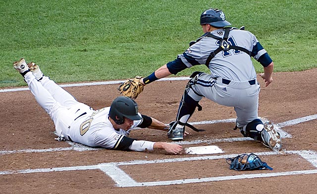 Vanderbilt's Bryan Reynolds slides safely around Jerry McClanahan's tag. (USATSI)