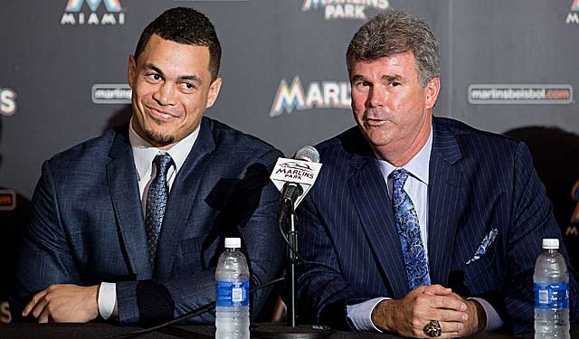 Dan Jennings (right) talks when Giancarlo Stanton is signed to a $325M contract. (Getty Images)