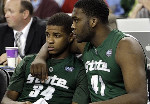 Marquise Gray consoles Korie Lucious as the Spartans fall well short against UNC.  