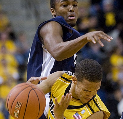 Missouri's Michael Dixon steals the ball away from North Florida's Brian Holmes in a game where the Tigers force 34 turnovers. (AP)