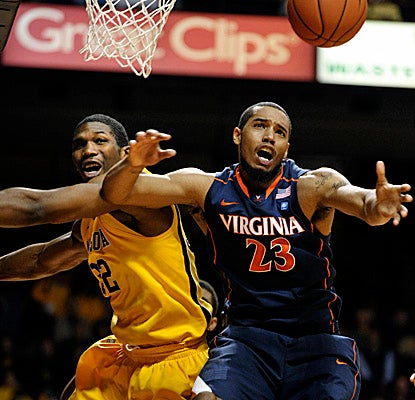 Minnesota's Trevor Mbakwe, left, and Virginia's Mike Scott battle for a rebound Monday. (AP)