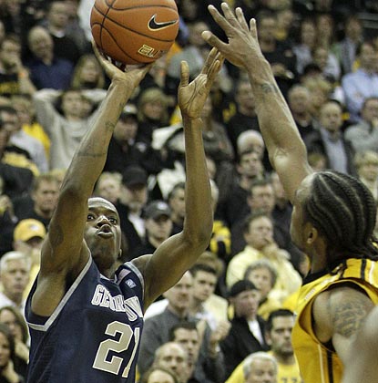 Jason Clark, shown shooting over Marcus Denmon, almost single-handedly defeats Mizzou in overtime with his 3-point shooting.  (AP)
