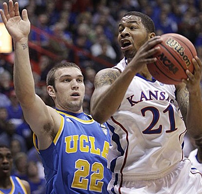 Kansas forward Markieff Morris, who finishes with nine points, drives to the basket while covered by UCLA's Reeves Nelson. (AP)