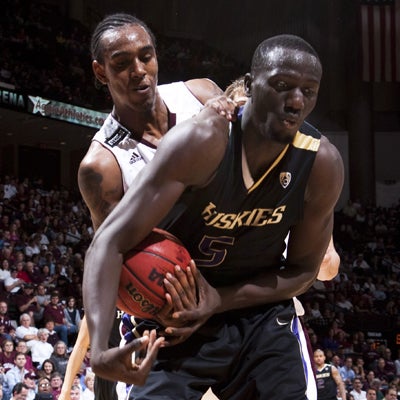 The Aggies' David Loubeau attempts to strip the ball before blocking the potential game winner.  (Getty Images)