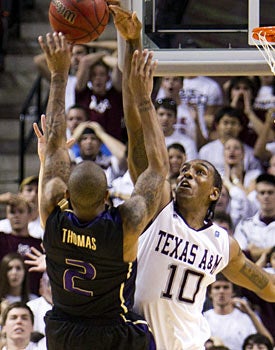 Isaiah Thomas' attempt at a game-winner is rejected by the Aggies' David Loubeau. (AP)