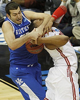 Josh Harrellson makes no mistake in his battle for the ball against Jared Sullinger. (AP)