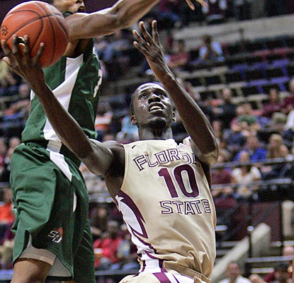 Florida State's Okaro White splits through Stetson's defense for 18 points to lead all scorers. (AP)