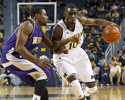 Tommie Tyler (left) and the Leathernecks keep up with Tim Hardaway Jr. and the Wolverines for most of the game.  (US Presswire)