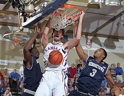 Kansas junior center Jeff Withey dunks against Georgetown forward Mikael Hopkins (3).  (US Presswire)