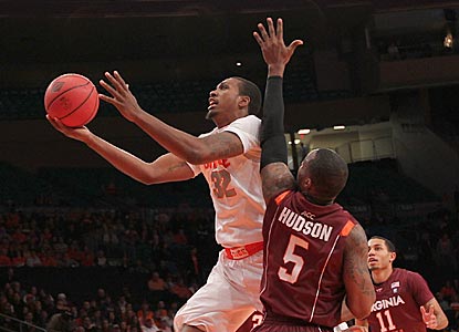 Syracuse's Kris Joseph drives past Virginia Tech's Dorenzo Hudson in the first half on the way to a 20-point night.  (US Presswire)