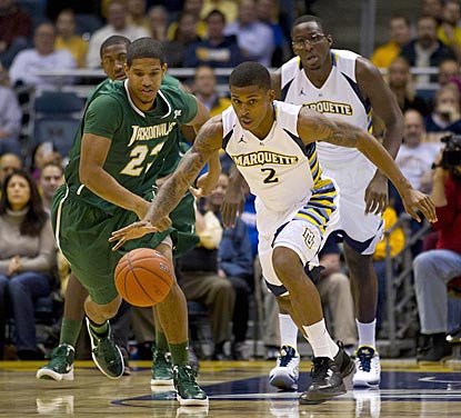 Marquette guard Vander Blue picks up a loose ball in front of Jacksonville's Tevin Galvin during the first half.  (US Presswire)