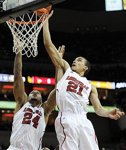 Louisville's Jared Swopshire (21) beats teammate Chane Behanan to the rim for a tip-in in the second half.  (US Presswire)
