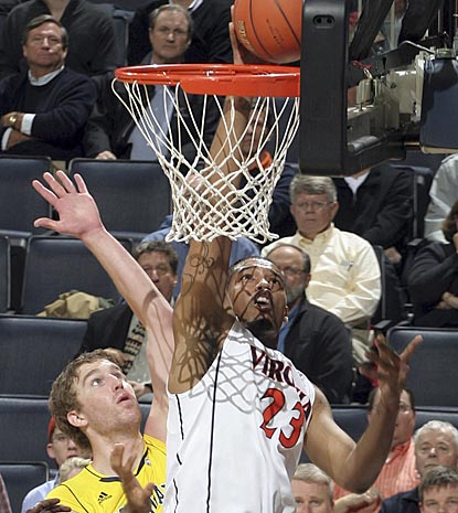 Virginia's Mike Scott goes the high-percentage route against Evan Smotrycz. Scott scores 18 points on 6-of-11 shooting.  (AP)