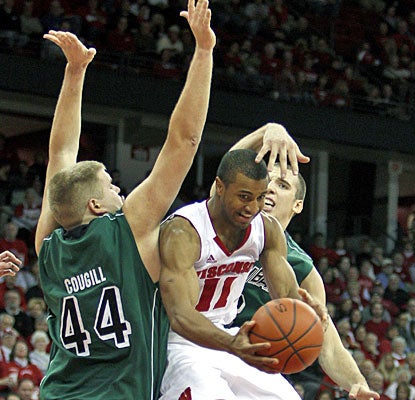 Jordan Taylor, who scores 15, finds room under double defense pressure from Brennan Cougill (44) and Daniel Turner. (AP)