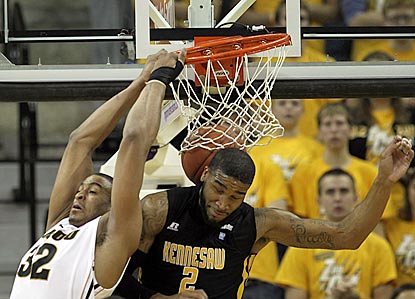 Missouri forward Steve Moore (left) posterizes Kennesaw State's Markieth Cummings with a backward dunk.  (Getty Images)
