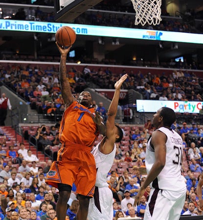 Kenny Boynton drives and scores here but does much of his work from downtown, nailing six treys. (AP)