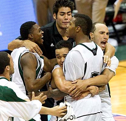 Hawaii forward Joston Thomas gets a big hug from teammates after scoring the winning layup vs. No. 14 Xavier. (AP)