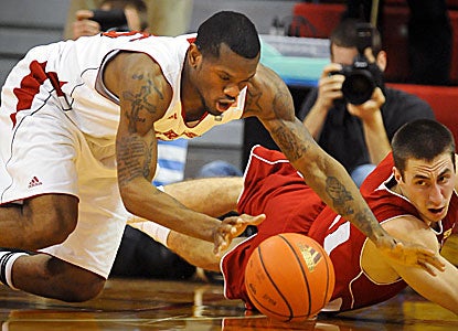 The Cornhuskers' Caleb Walker (left) battles Josh Gasser of the Badgers for a loose ball. (AP)