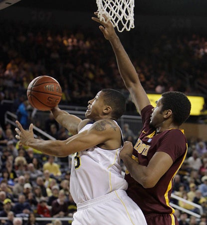 The Wolverines need every one of Trey Burke's season-high 27 points in a close one against Minnesota. (AP)