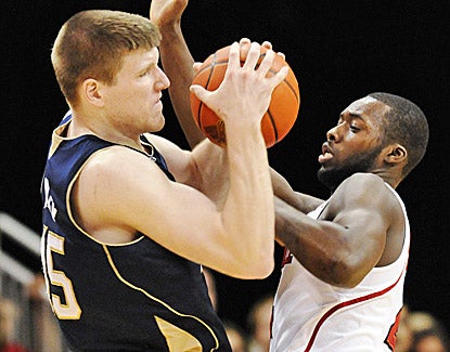 Notre Dame's Jack Cooley, who leads the Irish with 18 points and 10 rebounds, battles with Rakeem Buckles for the ball. (AP)