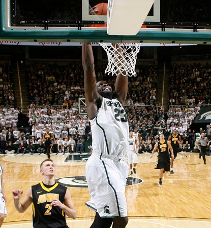 Draymond Green dunks here for two of his 22 points.  He adds 10 boards for a double-double. (AP)