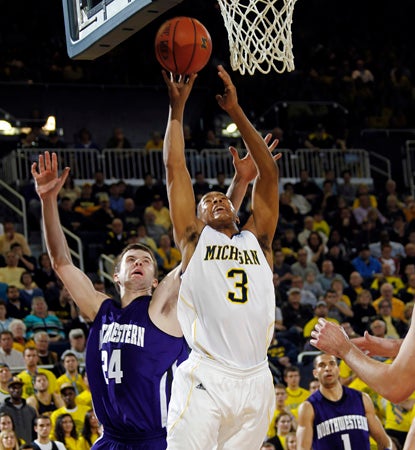 Trey Burke leads Michigan in a close one against Northwestern, scoring eight of his 19 points in overtime. (AP)