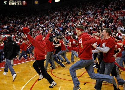 Nebraska fans storm the court after the Huskers beat the Hoosiers for their biggest victory as a new member of the Big Ten. (AP)