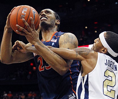 Virginia's Mike Scott scores 18 points, while fighting the Yellow Jackets for seven rebounds. (AP)