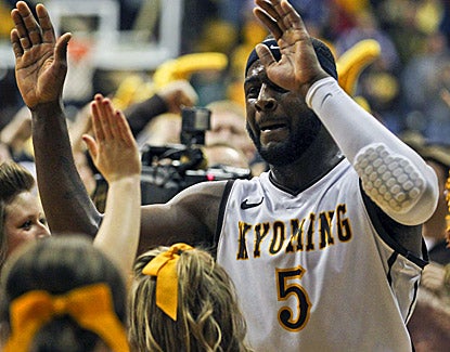 Wyoming's Leonard Washington, celebrating with fans, scores 16 points to help the Cowboys knock off No. 11 UNLV. (US Presswire)