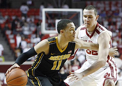 Missouri guard Michael Dixon, who winds up with 13 points, attempts to get past Casey Arent in the first half.  (AP)