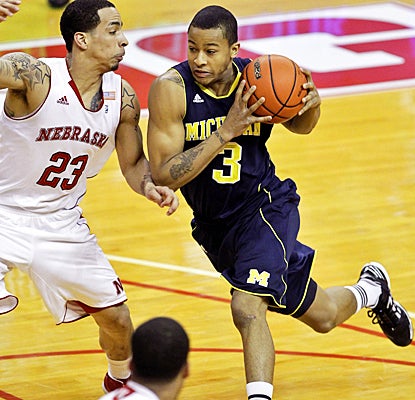 Michigan's Trey Burke drives past the Cornhuskers for 12 points, five rebounds and five assists. (AP)