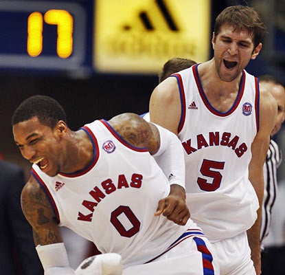 Thomas Robinson and Jeff Withey do most of the damage against Oklahoma State as they combine for 42 points and 34 boards. (AP)