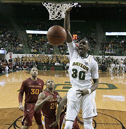 Baylor's Quincy Miller gets two of his 16 points the easy way while Tyrus McGee (25) and Royce White (30) can only watch.  (AP)