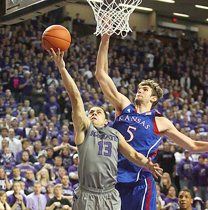 With Kansas up four in the final minute, Jayhawks center Jeff Withey (5) swoops in to block Angel Rodriguez's layup attempt.  (US Presswire)
